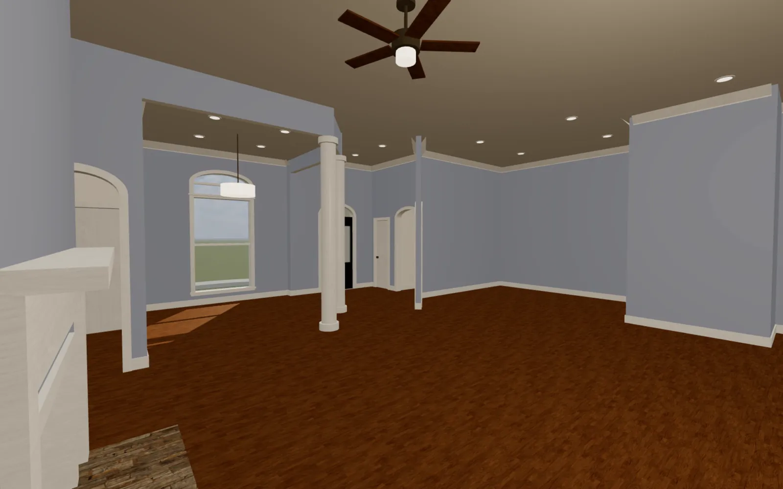 The blue-gray family room under a ceiling fan, with columns and arched openings to the rooms beyond.